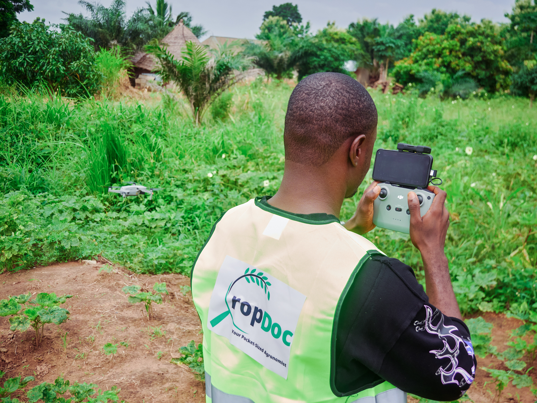 Technician operating drone for field scanning